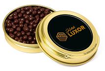Dark chocolate pearls in a gold caviar tin